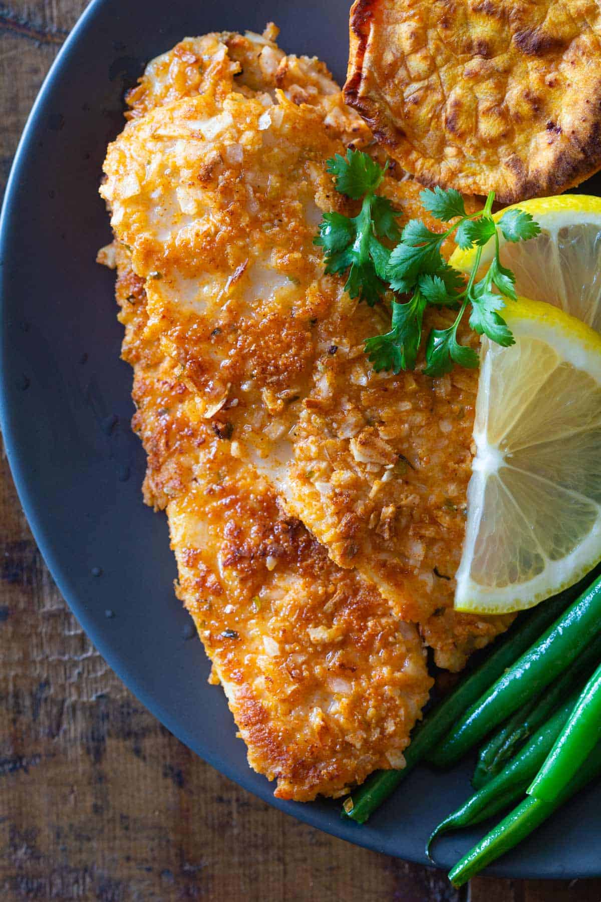 fried sole on -plate with lemon and herbs