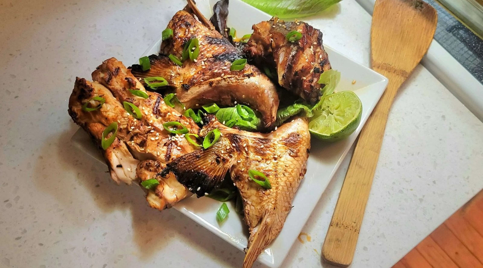 Grilled collars on a plate with lime