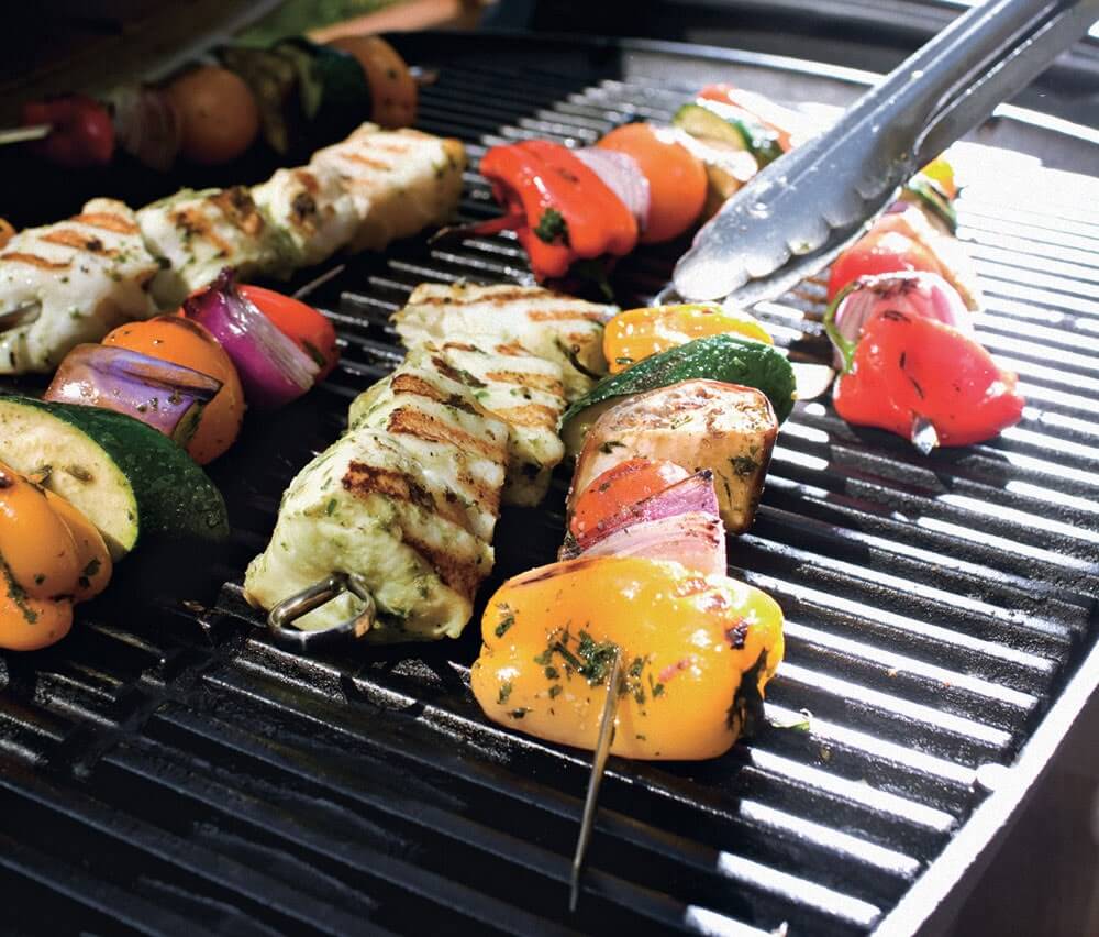 Skewers on grill with Halibut and vegetables