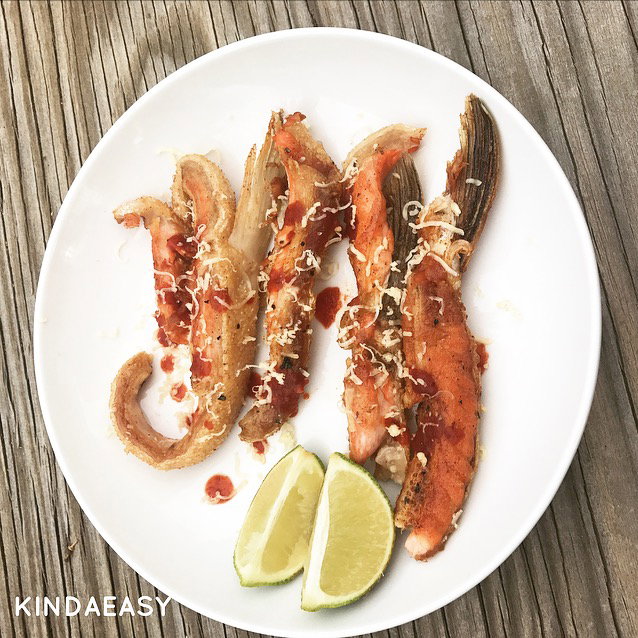 fried-salmon-bellies on white plate with lime