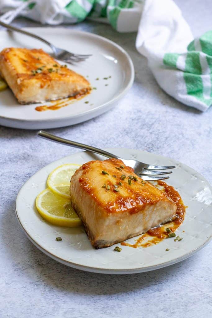 baked yellowtail on serving plates.
