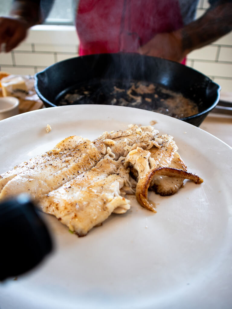 Cooked Easy Petrale Sole on white plate with stream rising from the fish