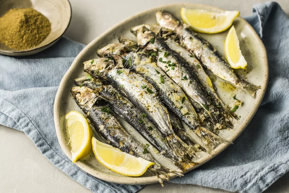 Moroccan Baked Whole Sardines on plate with four lemons